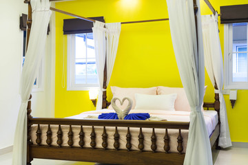 Fototapeta na wymiar luxury interior design of bedroom in cozy house with swan towel