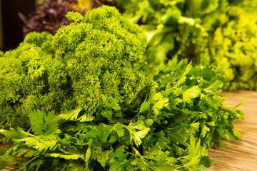 Fresh green parsley on a wooden background. Seasoning for the kitchen.