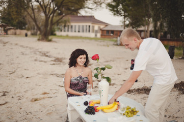 Couple in love gathered to have dinner by the water