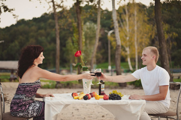Couple in love gathered to have dinner by the water