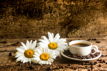 Coffee. A cup of coffee with grains on a wooden background