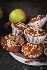 Autumn winter pastries. Vegan food. Healthy homemade baking cookies, muffins with nuts, apples, oat flakes. Cozy home atmosphere, warm blanket, ingredients. Dark stone table. Copy space