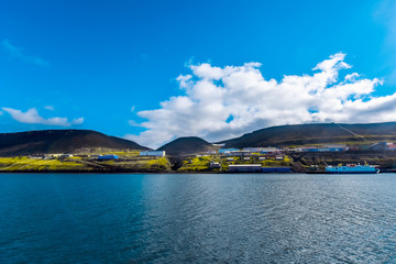 Landscape of the Russian  city of Barentsburg on the Spitsbergen archipelago in the summer in the Arctic In sunny weather and blue sky