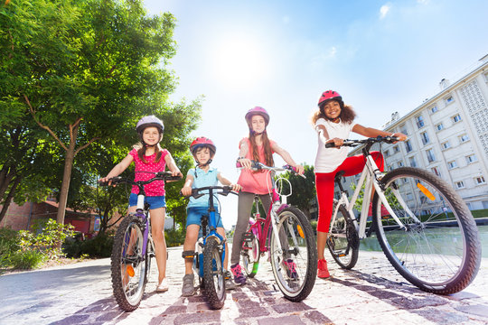 Happy children with bicycles in summer city