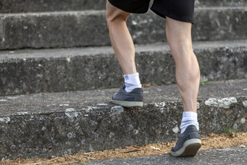 Young sportsman walking upstairs
