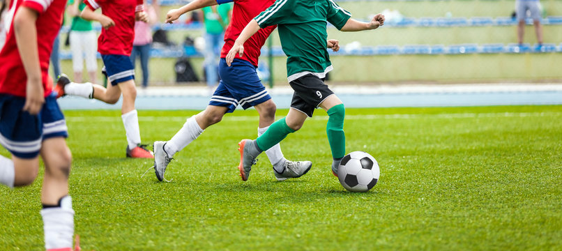 Soccer Player Action On Stadium. Youth Football Tournament Game. Kids Kicking Soccer Match