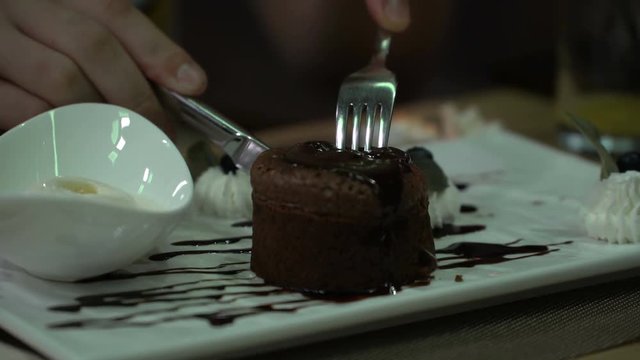 boy eating brownie with ice cream in a cafe.