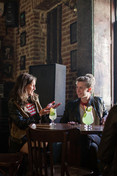 Friends talking at a table in a pub