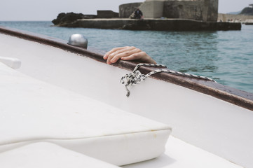 Hand gripping the boat