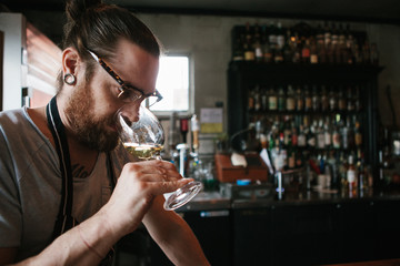 Hip bar owner tending his bar