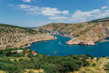 Fototapeta na wymiar Beautiful view of the summer Black Sea and Balaklava Bay. Panorama view to city, ships and port
