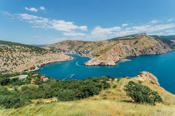 Obraz premium Beautiful view of the summer Black Sea and Balaklava Bay. Panorama view to city, ships and port