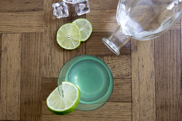 Gin gimlet cocktail with bottle