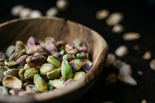 Pistachio nuts in a wooden bowl