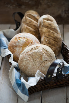 freshly baked loaves of bread on cutting ta