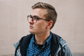 side profile portrait of young man in city