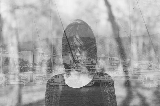 Double exposure of woman and sailboats