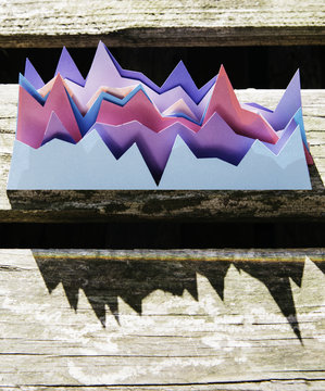 Creative colorful graphs behind each other with a prism effect in the shadow made by a ruler