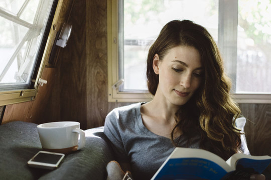 Young woman reading a novel