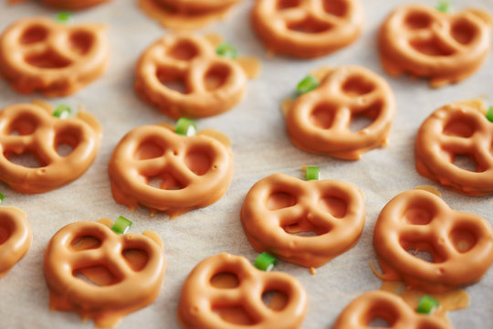 Preparing pumpkin shaped pretzels