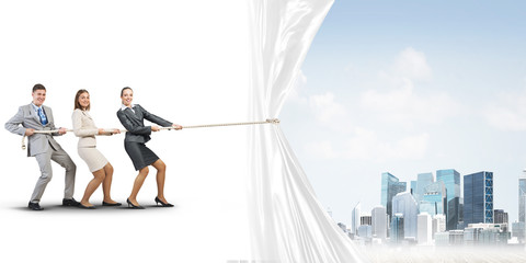 Young businesspeople working in collaboration and pulling white advertisement banner