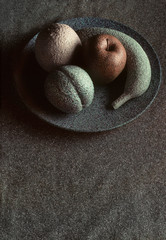 Granite-like sculpture of fruit on a plate