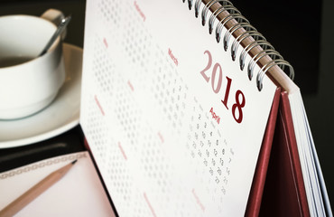 Desktop calendar sitting on desk showing year of 2018