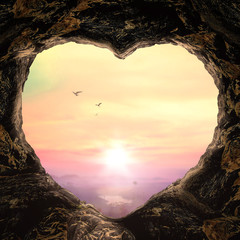 World environment day concept: Heart shape of cave on autumn sunset background