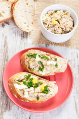 Slice of baguette with mackerel or tuna fish paste with egg and chives