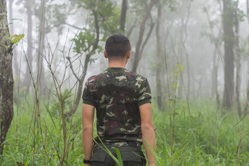 Man with green grass with morning mist