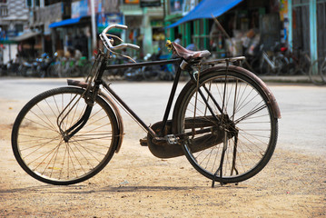 Fototapeta na wymiar Old bicycle standing on a street.