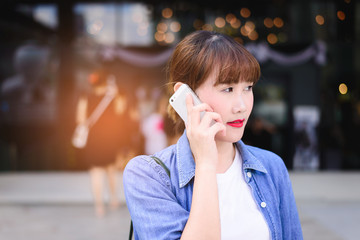 young asian woman use smartphone at city