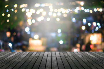 image of wood table and blurred bokeh background with colorful lights .