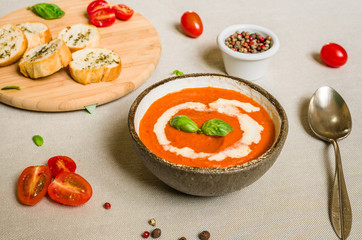 Colorful cream of tomato soup against white background. Healthy food, diet, and fitness concept