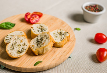 Bread toasts with spices and herbs against white background