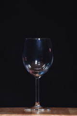 Empty Wine Glass in order on table over black