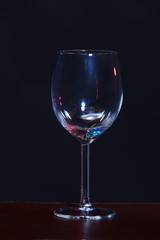 Empty Wine Glass in order on table over black