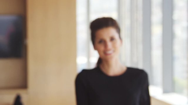 Portrait Of Businesswoman In Office Walking Towards Camera 