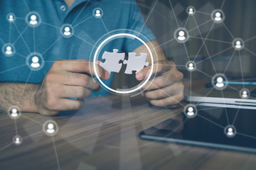 man holding pieces of jigsaw puzzle. business matching concept. crowd sourcing. freelancer....
