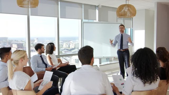 Businessman Making Presentation To Colleagues In Office