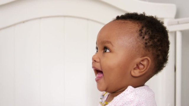 Happy Baby Girl Playing In Nursery Cot Shot In Slow Motion