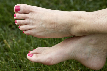 Middle aged Woman's barefeet in the grass