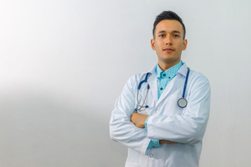 Asian smart doctor standing arms crossed and carrying stethoscope on shoulders at hospital, isolated on white background, concept of business advertising and consultation treatment patient.