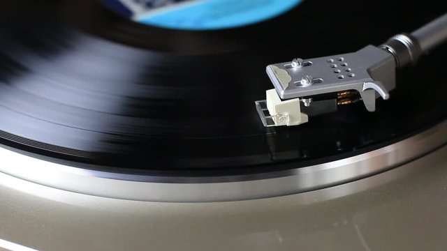 Vinyl record spinning close up, overhead