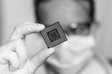 Scientist showing the computer microchip before repairs electron