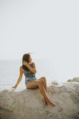 Fototapeta na wymiar Pretty young woman on the beach