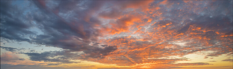 Naklejka na ściany i meble Fiery sunset, colorful clouds in the sky