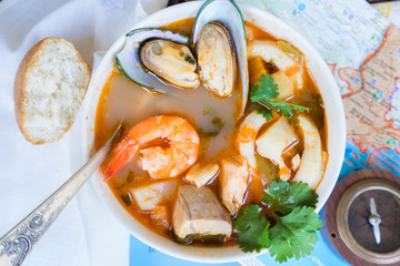 Bowl of Bouillabaisse french seafood soup with bread close up