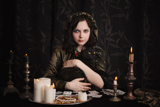 Young woman with divination cards in room