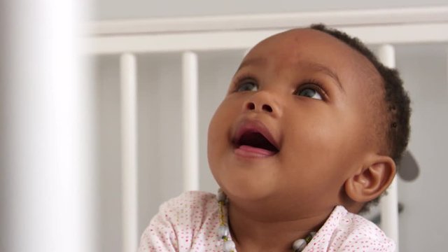 Happy Baby Girl Playing In Nursery Cot Shot In Slow Motion